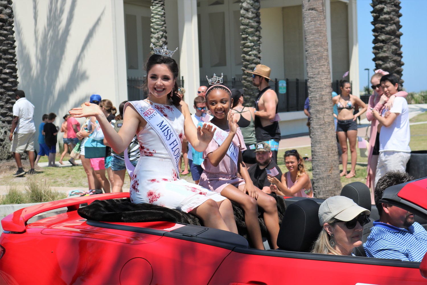 Miss Florida’s Outstanding Teen 2017 Reece Weaver (left) and her Sunshine Princess Gabby Watkins wave at the crowd as they drive by.